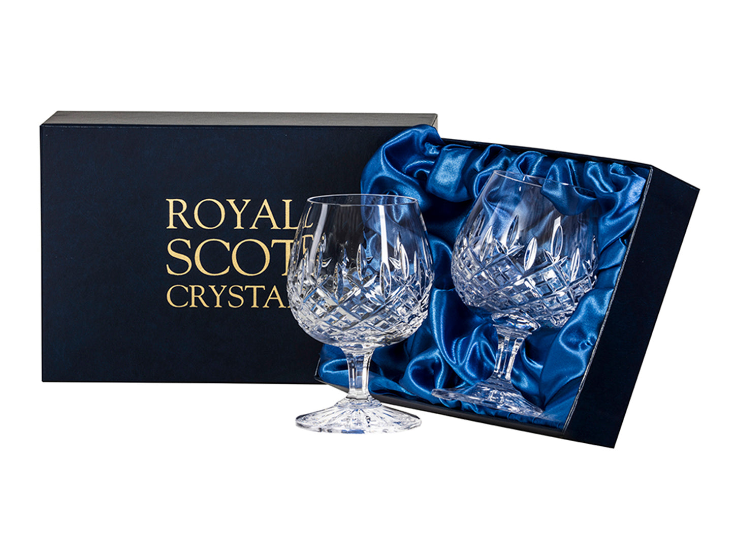 A pair of crystal brandy glasses with short stems and round bowls, cut with a bed of diamonds around the base of the bowl, with single flicks reaching up towards the smooth rim. They come in a navy-blue silk-lined presentation box with gold branding on the lid.