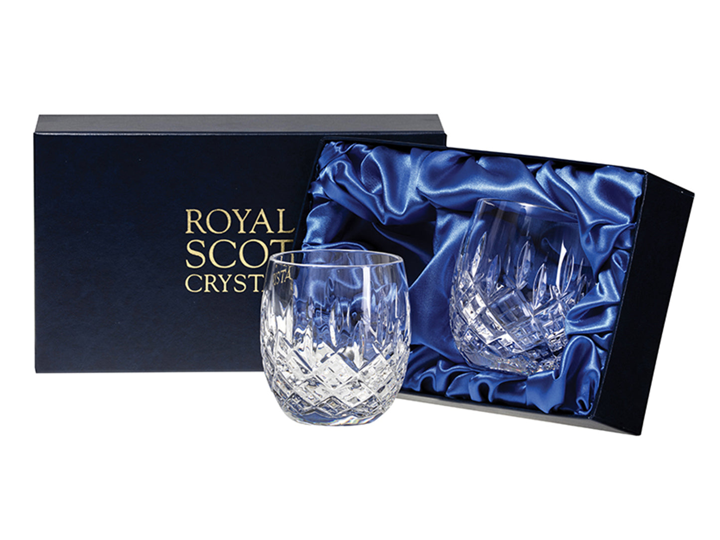 A pair of crystal tumblers with rounded bottoms, featuring a hand-cut design that contains a bed of diamonds and delicate dashes reaching up towards the smooth rim, packaged in a navy blue presentation box with satin lining.