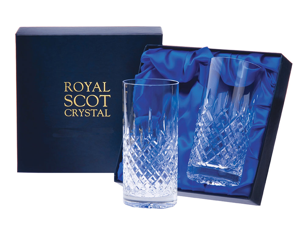 A pair of crystal highball glasses with a bed of diamonds around the base and single dashes reaching up towards the smooth rim. They come in a navy blue silk-lined presentation box.