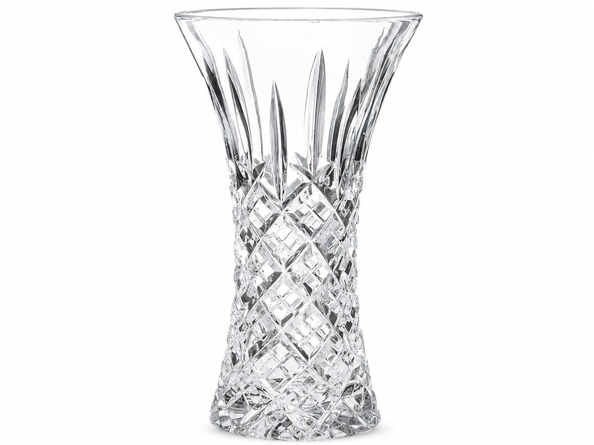 A large crystal vase with an hourglass shape that opens into a wide flare at the top. The cut pattern has a bed of diamonds around the base, topped with single flicks that reach up towards the smooth edge.