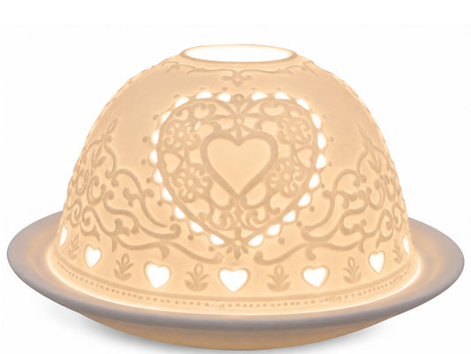 Light-Glow white unglazed porcelain dome tealight holder featuring an embossed lithophane design of a decorative heart pattern, glowing with warm ambient light from within.