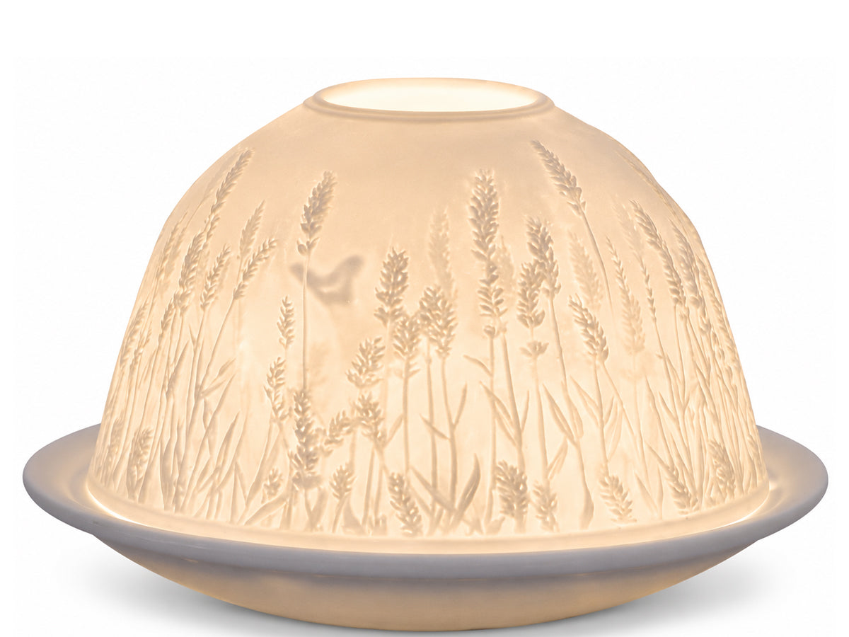Light-Glow white unglazed porcelain dome tealight holder featuring an embossed lithophane design of a lavender field and a small butterfly, glowing warmly from within.