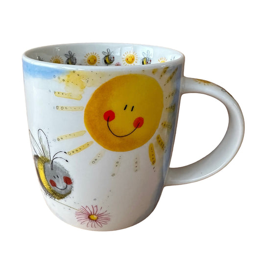 A lovely large bumble bee is illustrated on this mug basking in the sun & hovering over a flower, their are smaller bumble bees and happy suns illustrated on the inside rim and down the handle