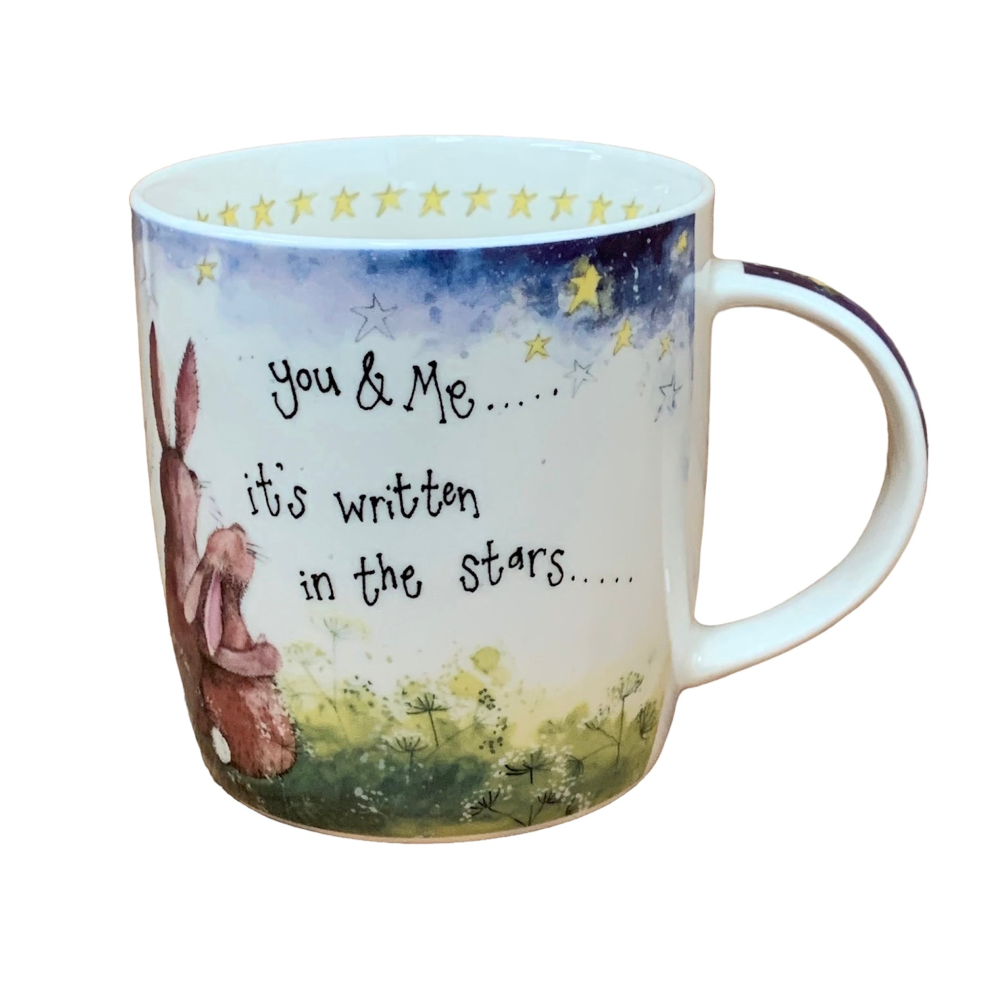 This Alex Clark mug is illustrated with 2 Bunnies looking up at the night sky and the words "You & me, it's written in the stars" on the side of the mug.  This mug also features yellow a stars illustration around the inside rim & illustrations down the handle.  