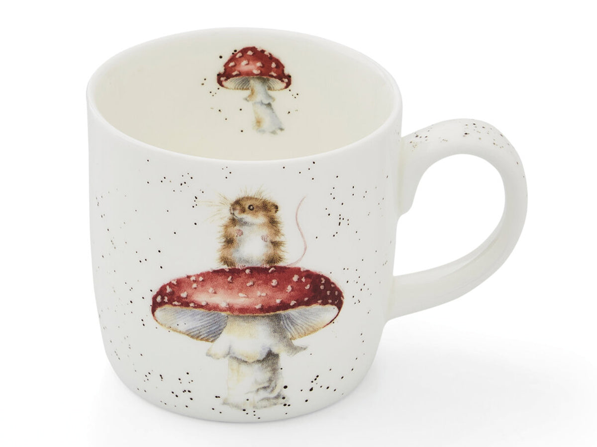 A white fine bone china mug with a red mushroom on it with a small brown mouse perched on top