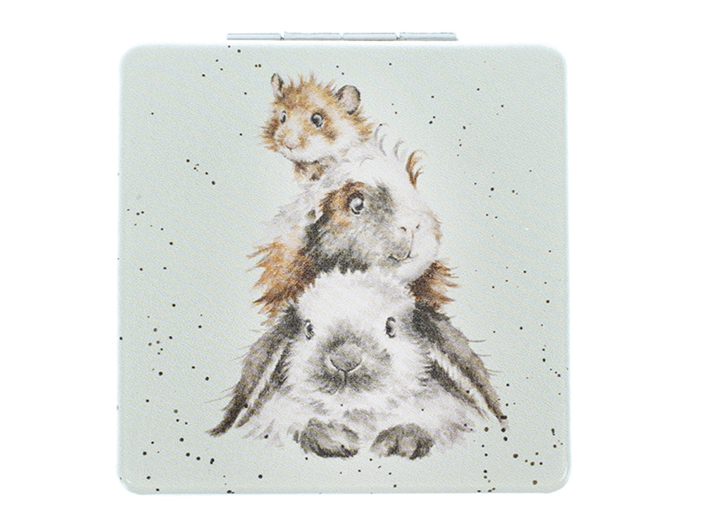 A light green square pocket mirror with a rabbit, guinea pig and hamster in a pile on the front, painted in a watercolour style