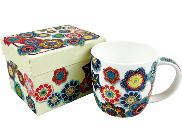 A white ceramic mug and matching gift box decorated with a colorful, intricate floral mandala pattern, shown on a plain white background.