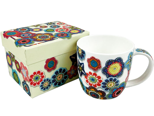 A white ceramic mug and matching gift box decorated with a colorful, intricate floral mandala pattern, shown on a plain white background.