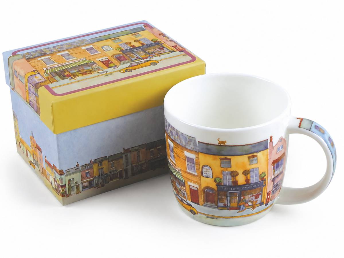 A white ceramic mug and its matching gift box, both decorated with a colorful illustration of a street scene featuring yellow buildings, storefronts, and a yellow taxi.