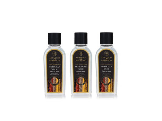 Three bottles of Ashleigh and Burwood lamp fragrance in a morrocan spice scent. The bottles are clear with black labels and caps, with a picture of dried spices in red, yellow and brown tones