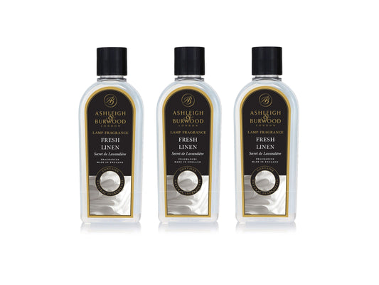 Three bottles of fresh linen lamp fragrance with clear bottles and black lids and labels