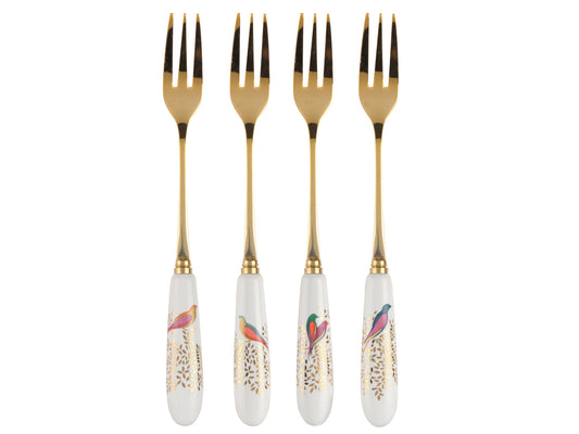 A set of four gold plated pastry forks with white porcelain handles, decorated with gold leaves and brightly coloured birds
