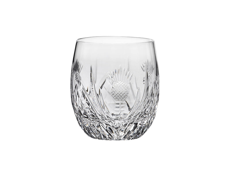A barrel-shaped crystal tumbler with a scottish thistle design cut into the exterior