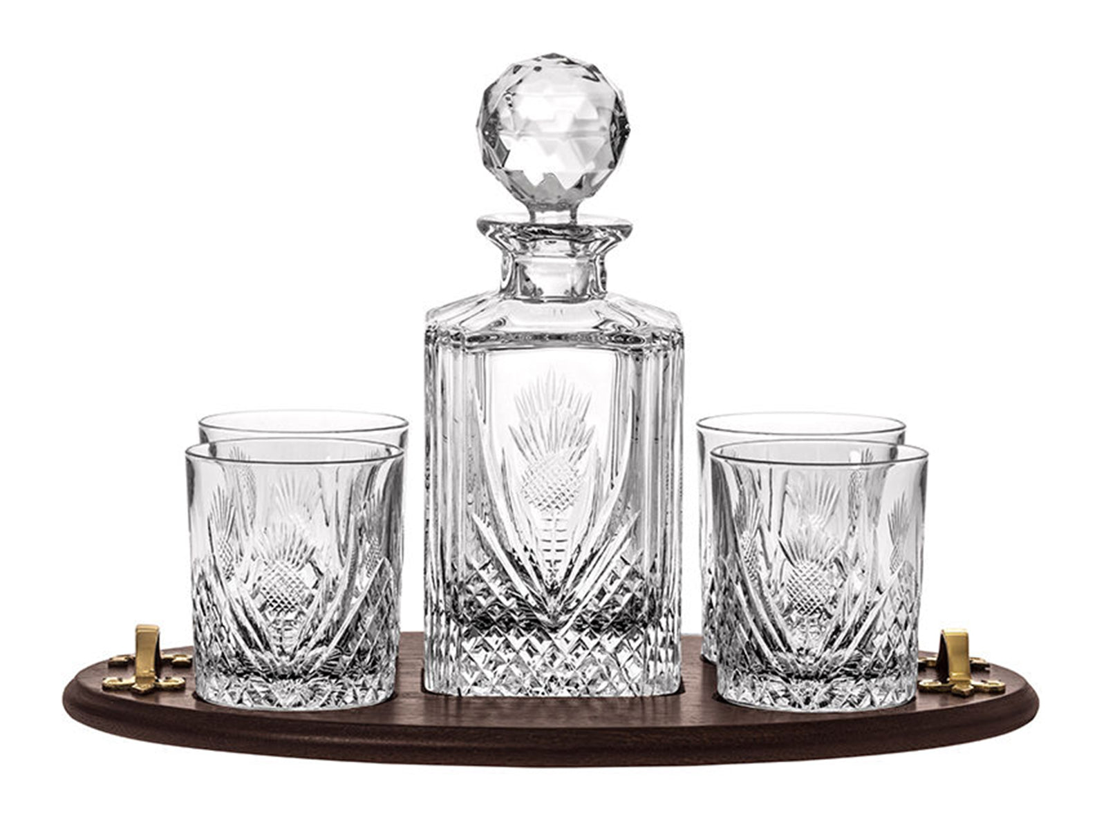 A crystal decanter and four matching glasses with a thistle design cut into the outside, sitting on an oak tray with gold handles