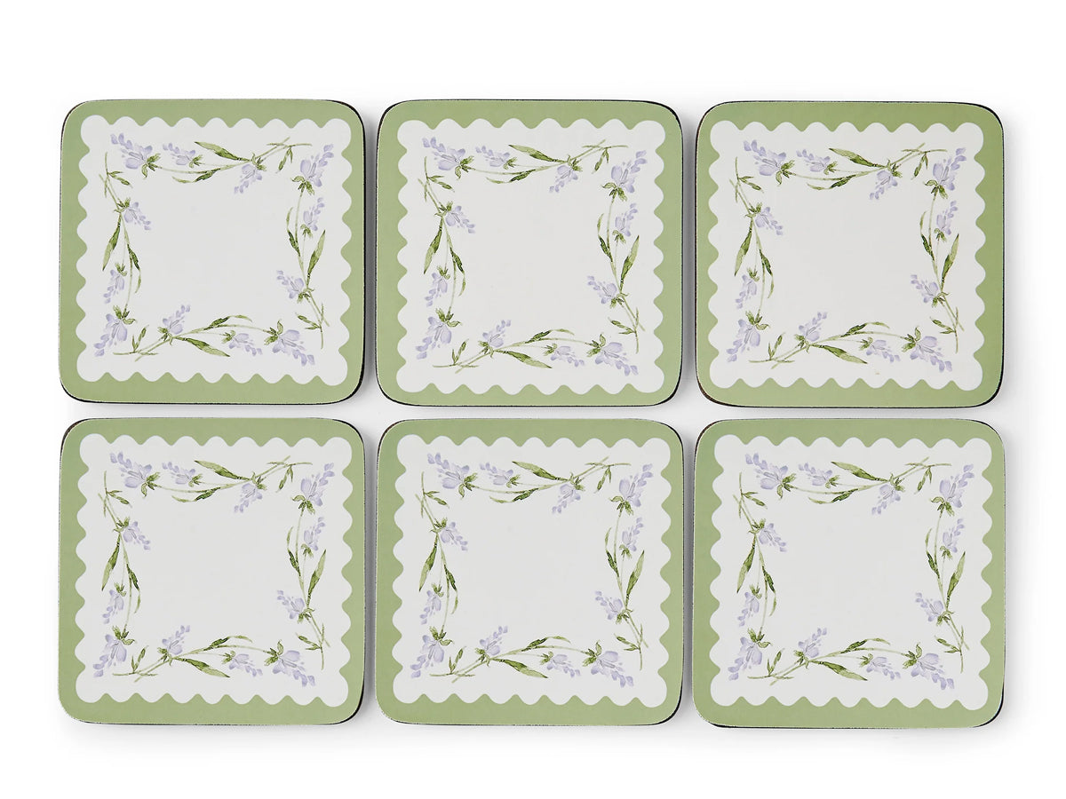 Set of six square coasters with floral design on a white background