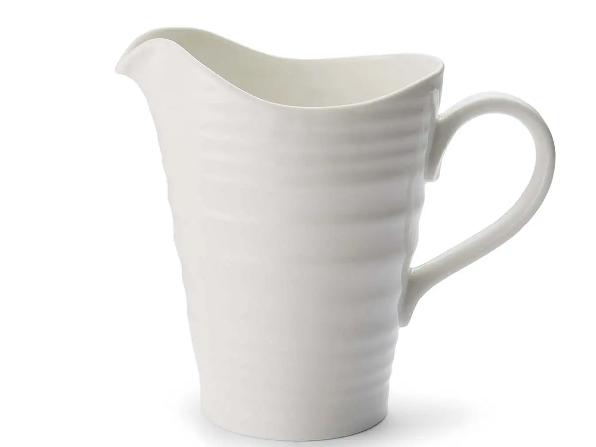 White porcelain Sophie Conran 1.5 pint pitcher with curved handle, pouring spout and signature ripple finish.