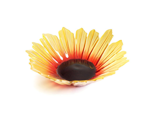 A crystal bowl in the shape of a sunflower, with yellow petals blending into an orange and brown centre.