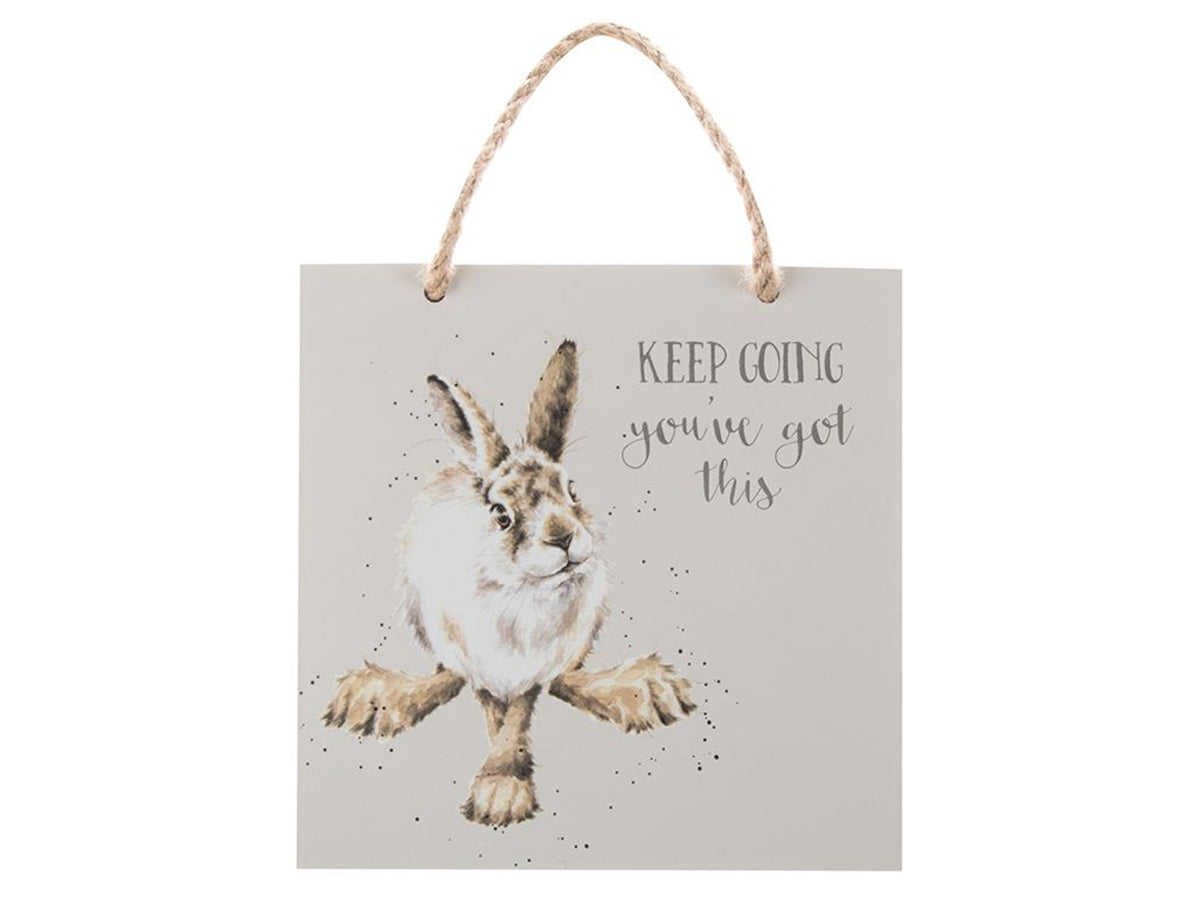 A light grey plaque with a hare on it