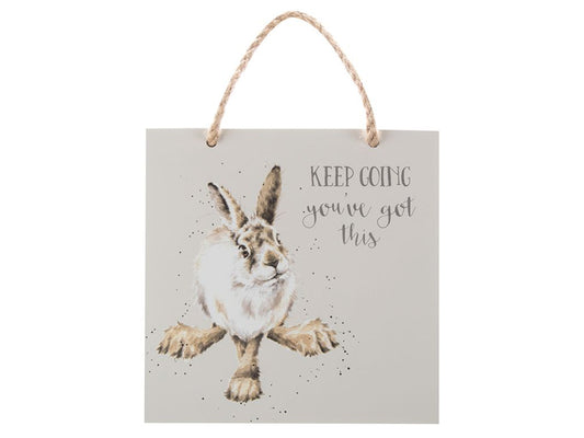 A light grey plaque with a hare on it