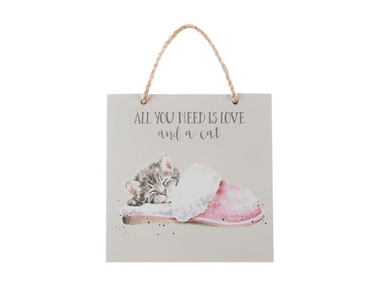 A pale purple plaque with a picture of a cat sleeping in a kitten on it