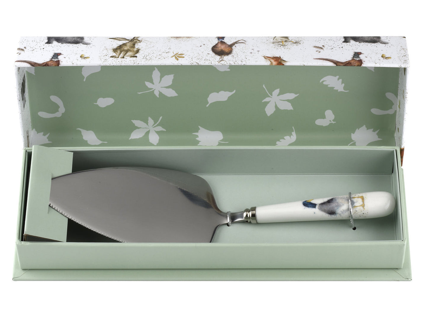 A silver cake slice with a white porcelain handle with a watercolour duck on it, in a light green and white box with animal designs on it