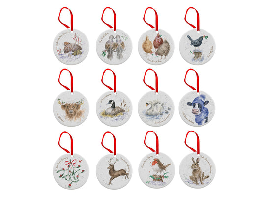 A set of 12 porcelain discs with animal designs on them, hung from red ribbon