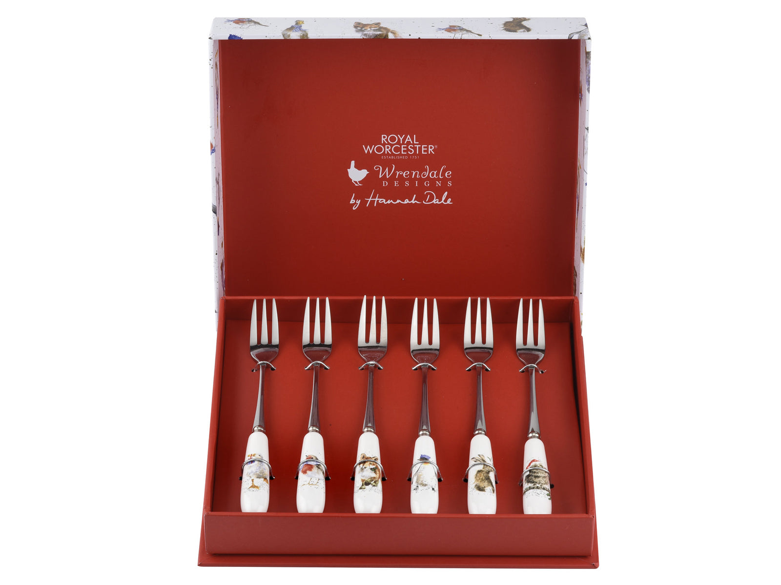 A set of six pastry forks with different animal designs on the handles, presented in a red box with a white lid which has more animal designs on it