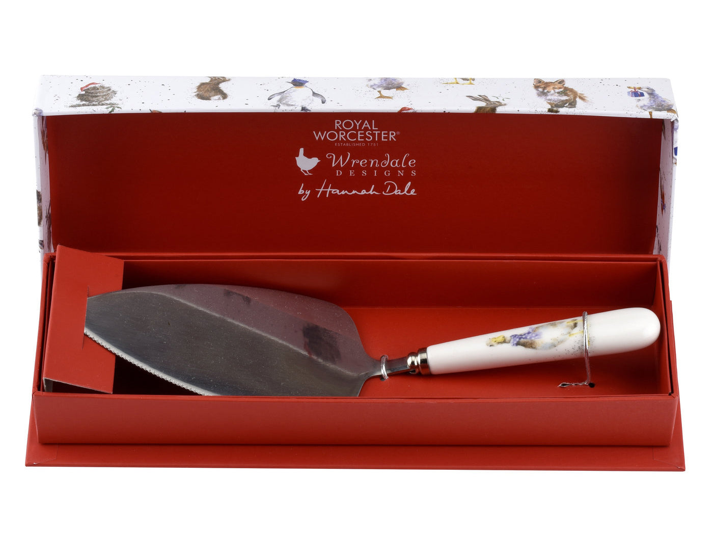 A silver cake slice with a white porcelain handle with a duck illustration on it, presented in a red and white gift box with animal illustrations on the lid