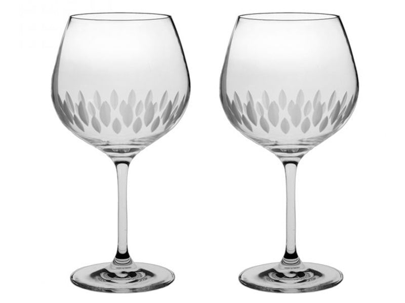 A pair of crystal gin copas with a delicate motif cut around the base of the bowl. The cut shapes are pointed ovals, giving the impression of lemon pips from above.