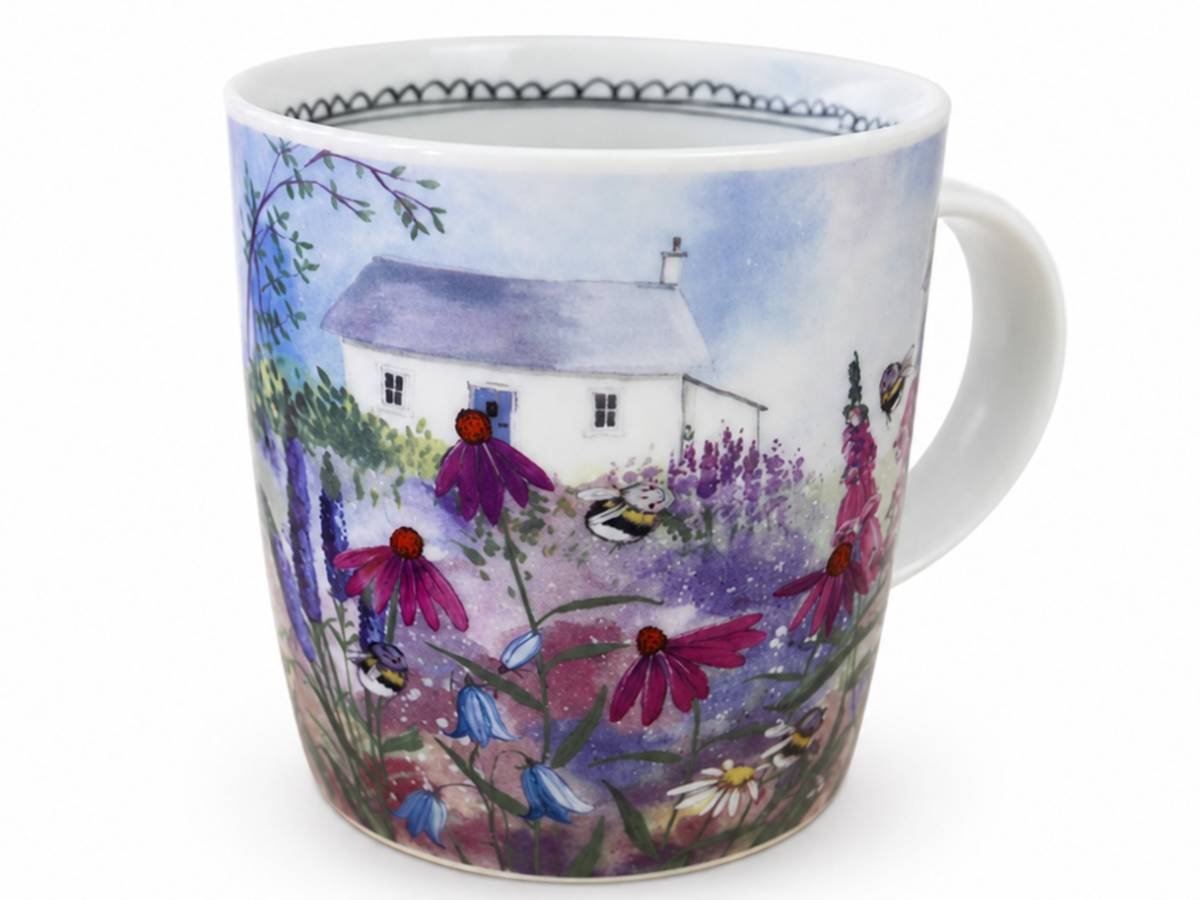 A white ceramic mug featuring a hand-painted watercolor landscape of a white cottage surrounded by purple and blue flowers under a soft blue sky.