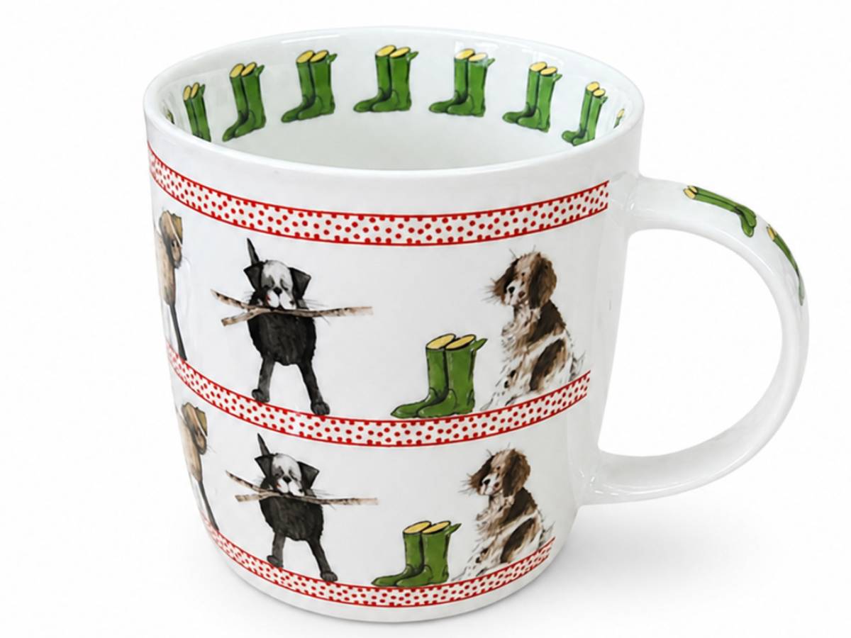 A white ceramic mug featuring a whimsical pattern of dogs holding sticks and green rain boots, separated by red dotted borders, on a clean white background.