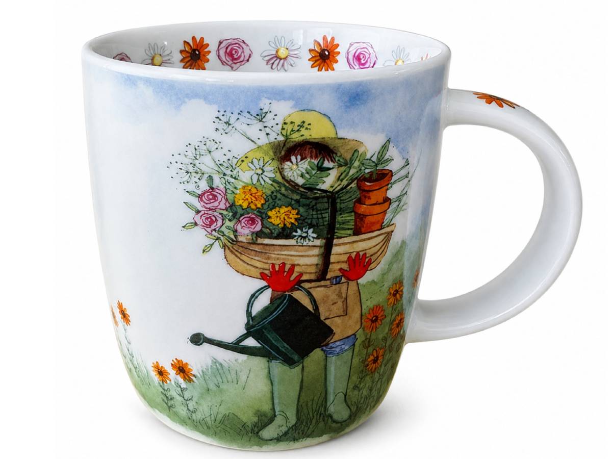 A white ceramic mug featuring a whimsical illustration of a person gardening, carrying a basket of flowers and plants while wearing a yellow hat and green boots. The mug is decorated with a blue sky and white clouds on the upper portion, and orange flowers along the rim and base.