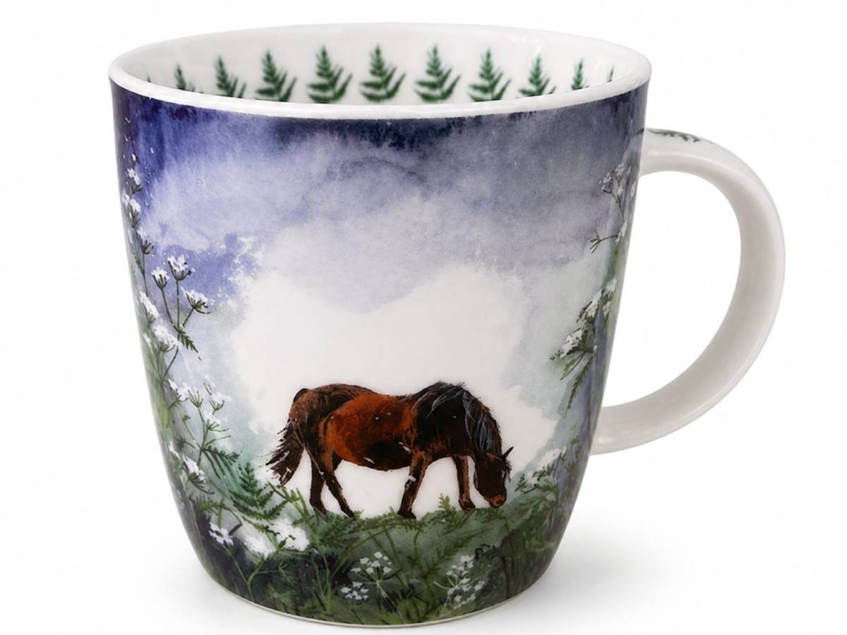 A white ceramic mug featuring a hand-painted winter landscape design with a brown horse, green pine trees, and snow under a blue sky.