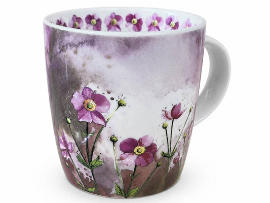 A white ceramic mug decorated with a watercolor-style floral design featuring purple flowers and green stems against a soft gray and purple background, with a matching row of small purple flowers around the inner rim.