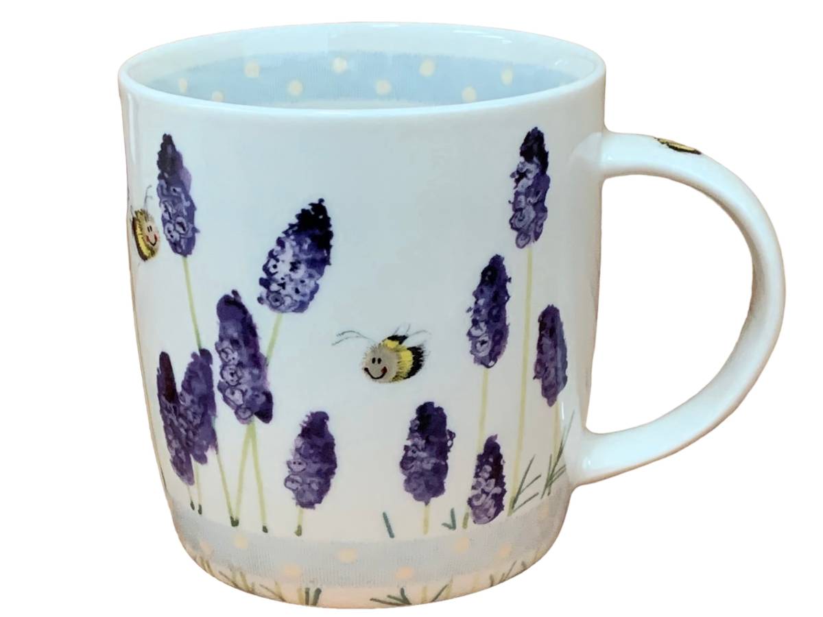 A white ceramic mug decorated with purple lavender flowers, green stems, and two small bees, shown against a plain white background.