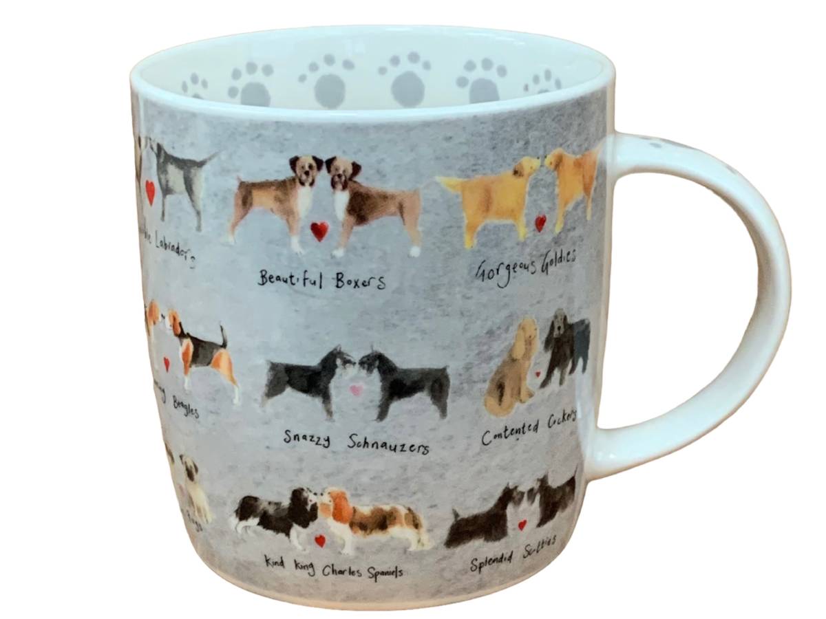 A white ceramic mug featuring a light gray printed design with various dog breeds illustrated in pairs, each with a small red heart and handwritten breed names. The mug is shown on a plain white background.