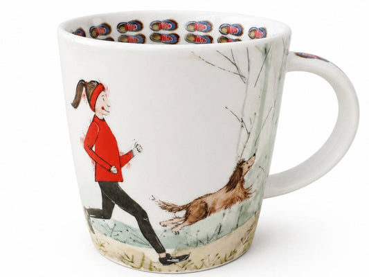 A white ceramic mug featuring a whimsical illustration of a woman in a red jacket running alongside a brown dog in a snowy outdoor scene. The inside of the mug is decorated with a repeating pattern of colorful shoes.