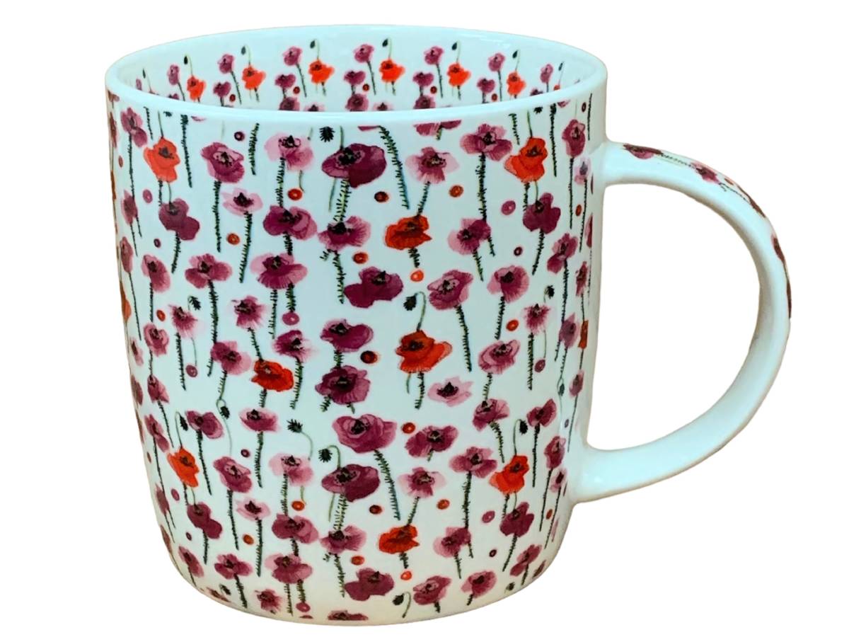 A white ceramic mug decorated with a dense pattern of red, pink, and purple poppy flowers with green stems, shown against a plain white background.