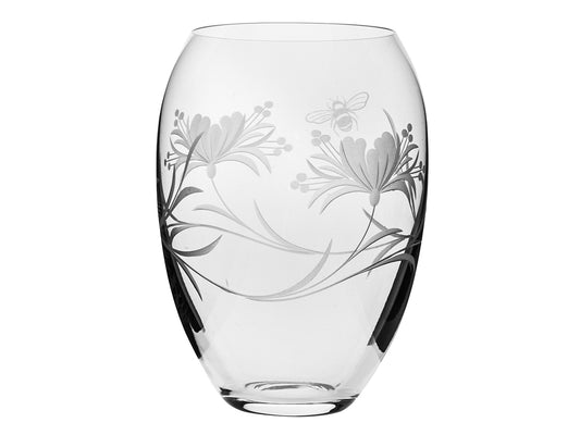 This Royal Scot Crystal Bee & Honeysuckle Medium Barrel Vase has been hand-cut in Britain by skilled artisans, who have captured a frosted scene of honeysuckle flowers and a bumblebee around the exterior of the vase. Rounded in shape and tapering at the top, this vase is ideal for displaying all manner of flowers.