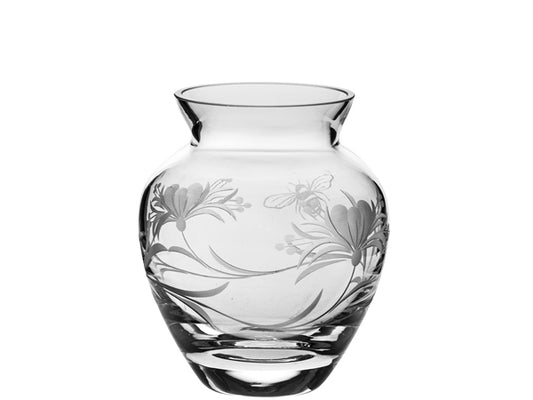 This Royal Scot Crystal Bee & Honeysuckle Small Posy Vase is dainty in size and would be perfect for displaying your favourite small-stemmed flowers. Hand-cut in Britain, the vase is decorated with honeysuckle flowers around its exterior, along with a bumblebee flying amongst them. It has a tapered neck that widens out into a rounded body, and is complete with a thick-weighted base.