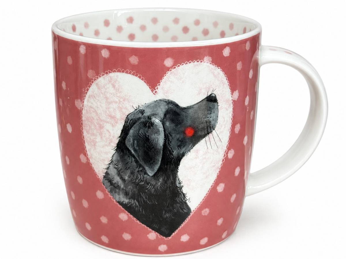 A ceramic mug with a red and white polka dot pattern, featuring a central white heart-shaped frame containing a black dog illustration with a small red nose.