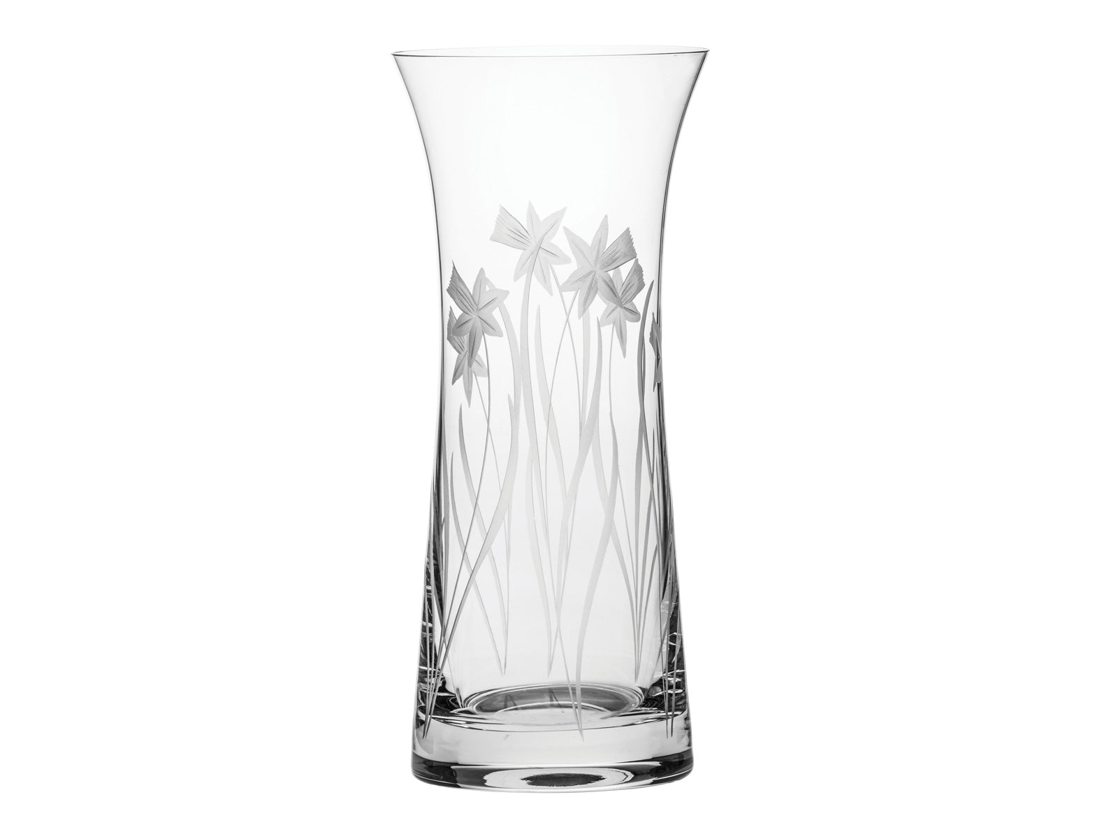 A crystal vase that is tall and flared at the top, engraved with daffodils on the outside.
