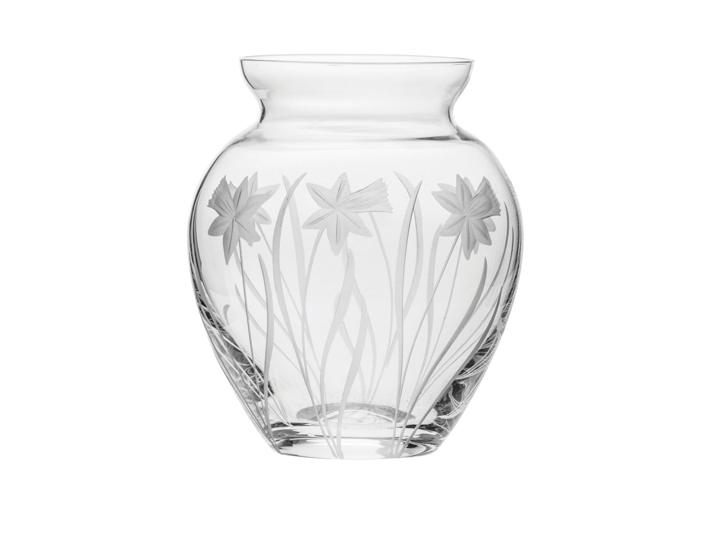 A small crystal vase with daffodils engraved around the outside