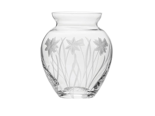 A small crystal vase with daffodils engraved around the outside