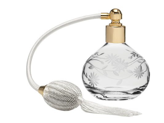 A crystal perfume atomiser with an engraved daisy design and a cream puffer