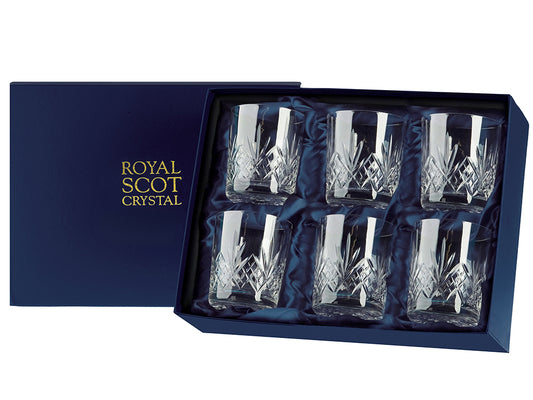 A set of six large whisky tumblers with a bed of diamonds cut around the base, topped with a deep five-pointed fan and a clear rim. They come in a navy-blue silk-lined presentation box with gold branding on the lid.