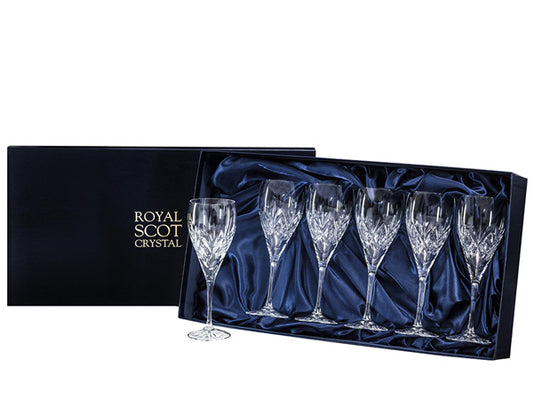A set of six wine glasses with a bed of diamonds cut around the base of the bowl, topped with a five-pointed fan. They come in a navy-blue silk-lined presentation box with gold branding on the lid