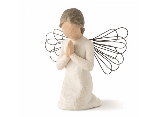 A cast stone figurine of a faceless angel with wire wings. The angel is kneeling on the ground, her hands clasped together in a prayer pose. She has brunette hair tied back in a bun. She wears a white dress with a crackle texture, revealing the natural brown color of the stone. The rest of the angel is painted in earthy colours.