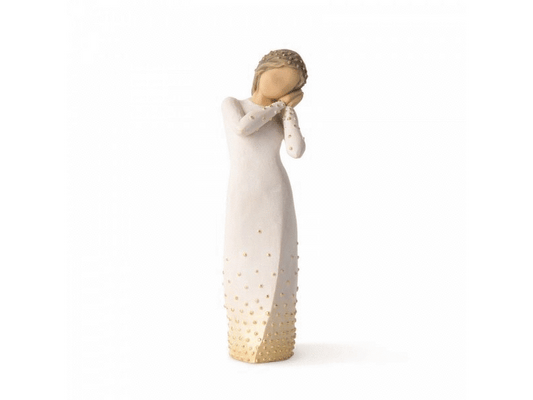 A cast stone Willow Tree figurine. A faceless feminine figure, in a wishful pose. with a gold embellished dress.