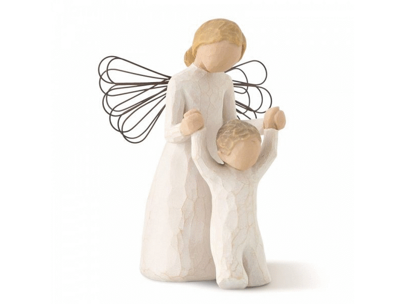 This Willow Tree figurine titled "Guardian Angel" shows a smooth, featureless angel, holding up the arms of a faceless little boy, who is standing on the ground. The angel's wings are made from wire and suspend delicately from her back. Carved with intricate details, the angel is dressed in an all white dress that drapes down to her feet. The little boy is also dressed in a simple all white one piece. The figurine captures the essence of protection, guidance, and comfort, and its soothing presence brings a 
